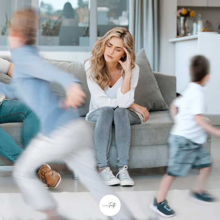 An image of a stressed out mom with kids running around her