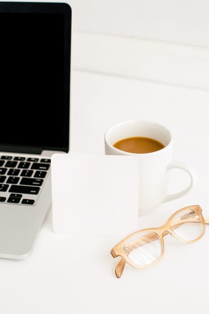 a laptop and coffee and glasses