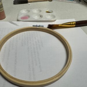 embroidery hoop with pink paint and brush for Christian craft project