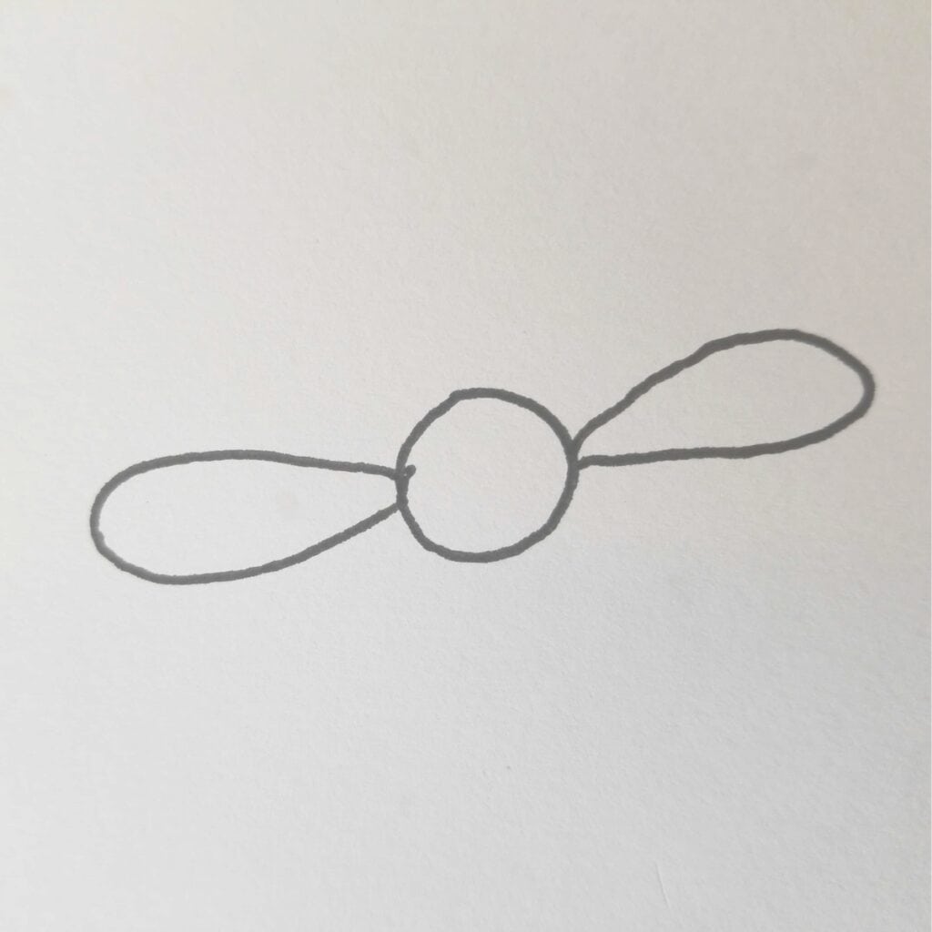 Bible Journaling Drawings: Simple & Beautiful Ways to Worship Through Art (Even If You’re Not an Artist) 11 Initial step of drawing a daisy for Bible journaling, featuring a central circle with two opposing oval petals sketched in pencil”