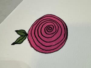 Bible Journaling Drawings: Simple & Beautiful Ways to Worship Through Art (Even If You’re Not an Artist) 18 Completed spiral rose drawing with bold black outlines, vibrant pink petals, and green leaves on textured paper — an easy flower design for Bible journaling